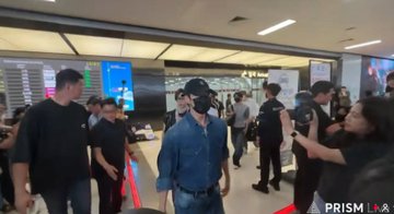 ALD1 members, including Junseo, arrive at Gimpo Airport after returning from "GMP," greeted by fans in what appears to be a busy terminal.