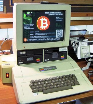An Apple II computer displays a Bitcoin cryptocurrency screen on its monitor, with the iconic orange Bitcoin "B" logo prominently featured alongside a wallet address and QR code. This vintage 1983 home computer, fitted with 5¼-inch floppy drives labeled "DISK 1" and "DISK 2," represents the impressive feat of mining bitcoin on retro eight-bit hardware, as referenced in the accompanying post about the developer's optimization work.