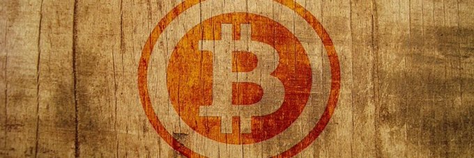 A textured, vintage-style banner featuring the orange Bitcoin (₿) logo painted or printed on a weathered wooden plank background.