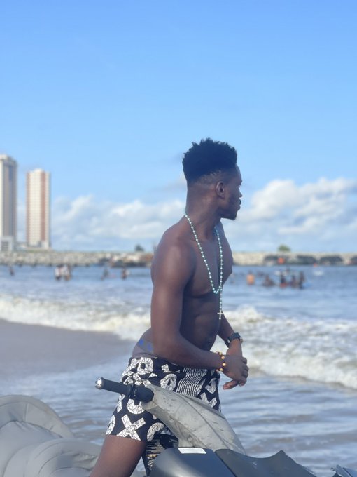 A shirtless man rides a jet ski along the shoreline, with high-rise buildings and beachgoers visible in the background, capturing a quintessential weekend escape that lives up to the post's celebration of getting outdoors.