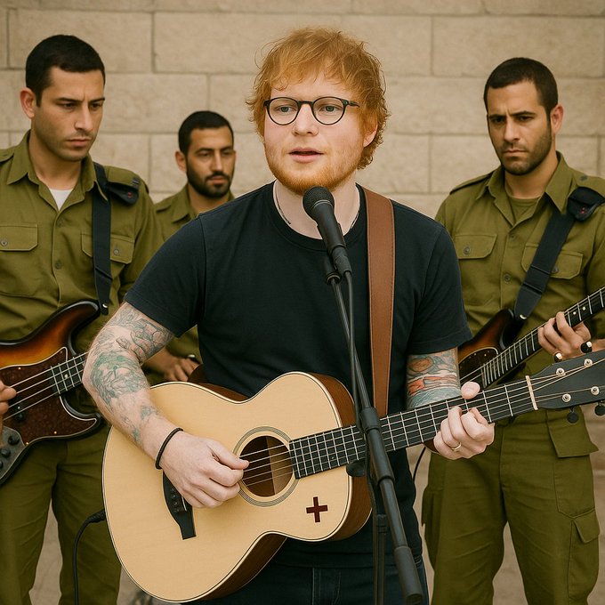 Ed Sheeran, wearing a black t-shirt and glasses, plays an acoustic guitar and sings into a microphone, backed by musicians in olive-green uniforms.