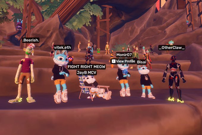 A screenshot from a virtual 3D social game (likely Decentraland) showing various avatars gathered, with usernames like '.Beerish.', 'vitek.eth', 'FIGHT RIGHT MEOW', 'JayB MCV', 'Monir07', '__OtherClaw__', and 'Bisai' visible above their heads.