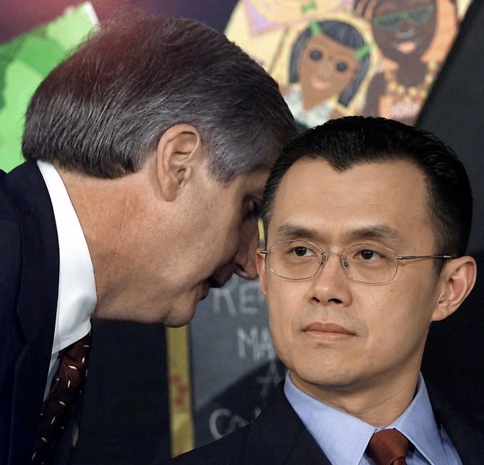 A photo showing a man whispering into the ear of another man wearing glasses, who is identified by the caption as Zhang Yiming, the founder of ByteDance, sitting in front of a colorful mural.