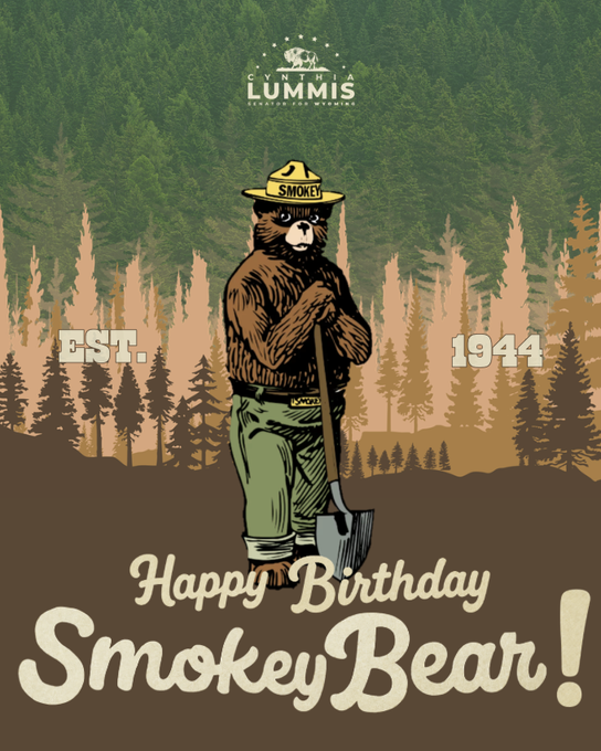 A vintage-style poster featuring Smokey Bear wearing a ranger hat labeled 'SMOKEY' and holding a shovel, with text reading 'EST. 1944' and 'Happy Birthday Smokey Bear!' against a forest backdrop.