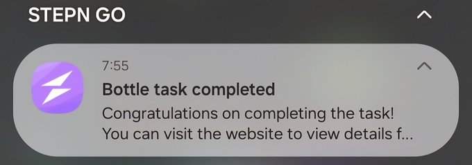 The image shows a message from StepN Go, congratulating someone for completing their bottle task. The text reads "Congratulations on completing the bottle task!". The image also includes an icon of a bottle with a lightning bolt symbolizing the completion of the task.