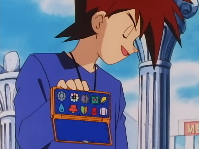 An anime character with red hair wearing a blue shirt holds an open case displaying various colorful icons, set against a background featuring blue sky and ornate pillars.