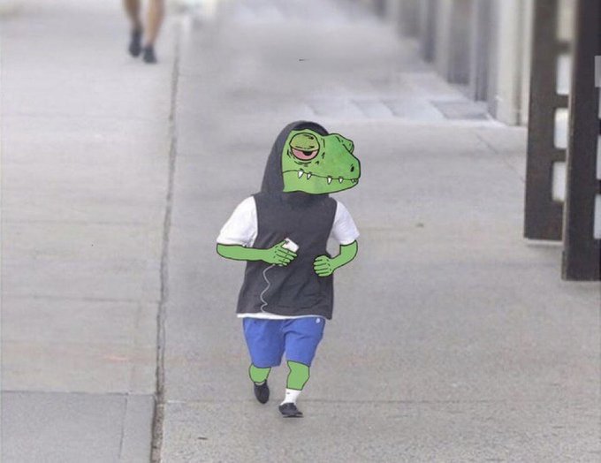 A child walks down a sidewalk wearing a black t-shirt over a white shirt and blue shorts, holding a small device, with cartoon crocodile/animal features digitally edited onto the photo.