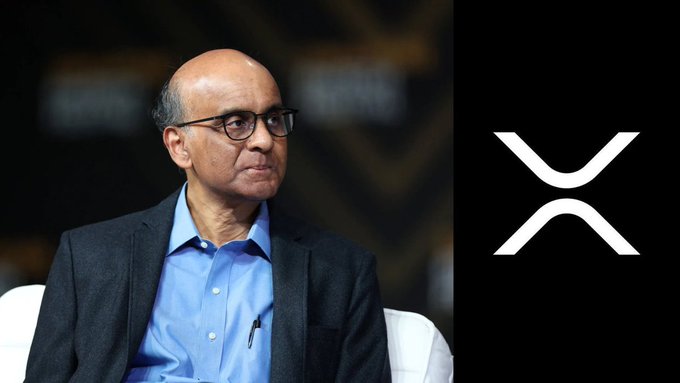 An older man wearing glasses, a blue shirt, and a dark blazer appears alongside the XRP crypto logo, visually tying to news that Singapore now offers a 0% capital gains tax on XRP for individual investors.