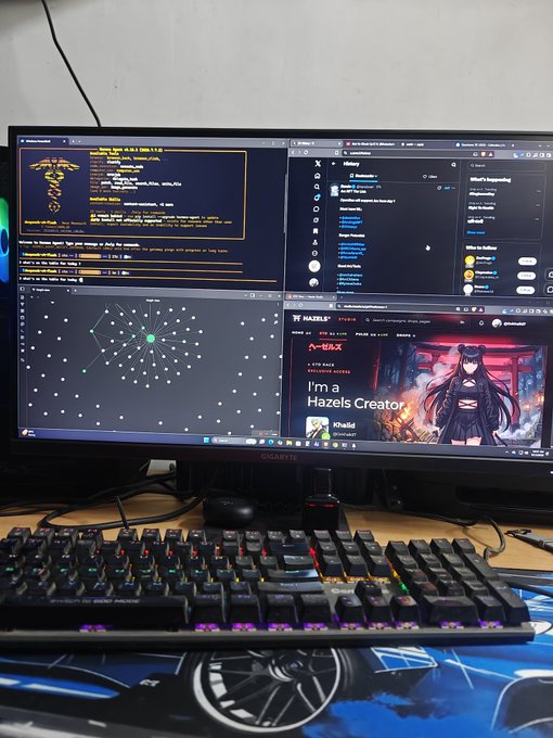 A photo of a desk setup showing a curved monitor displaying multiple windows including code, an Alienware interface, and a 'HAZEL's STREAM' page with 'I'm a Hazels Creator' text, along with a colorful RGB gaming keyboard.