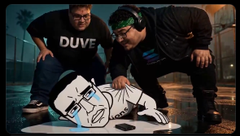 Two men wearing "DUVE" shirts tend to a monkey lying on the ground, with one wiping its mouth using a "BOYZ" bandana. The scene ties to the post's theme of the $BOYZ crew protecting their own while keeping their signature bandana visible.