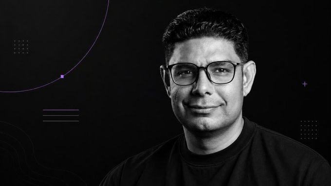A black-and-white portrait of a smiling man with glasses and dark hair, set against a dark background with purple geometric accents. The post identifies him as @Gaurav_ionet, CEO of @ionet, commenting on NVIDIA's GPU access strategy.