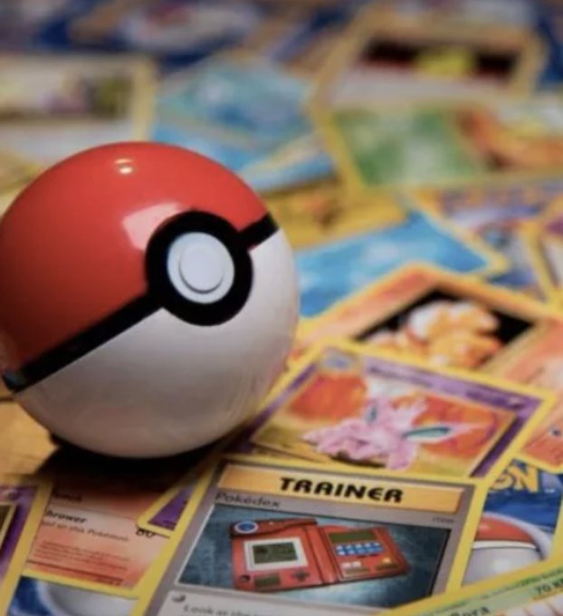 A classic red and white Poké Ball rests atop a scattered pile of Pokémon trading cards, with a "TRAINER" Pokédex card clearly visible in the foreground. The image perfectly complements the post's nostalgic theme of discovering that tokenized Pokémon cards and rare physical cards like the $16.5M Pikachu Illustrator represent a legitimate real-world asset opportunity rooted in childhood nostalgia.