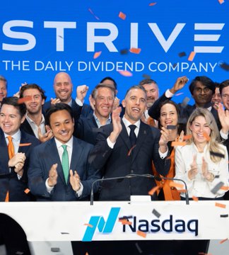 A jubilant group of Strive executives and staff celebrate at the Nasdaq podium with confetti flying, alongside the "STRIVE - THE DAILY DIVIDEND COMPANY" backdrop. The image captures the company's celebratory corporate milestone as Strive expands its Bitcoin holdings to 20,246 BTC.