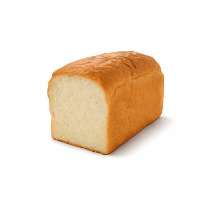 A simple loaf of white bread with a golden-brown crust sits against a plain white background, showing the soft white interior where one end has been cut.