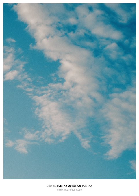 A blue sky filled with scattered white clouds, photographed on a PENTAX Optio H90 camera (58mm f5.3 1/160s ISO80), as noted by the caption at the bottom.