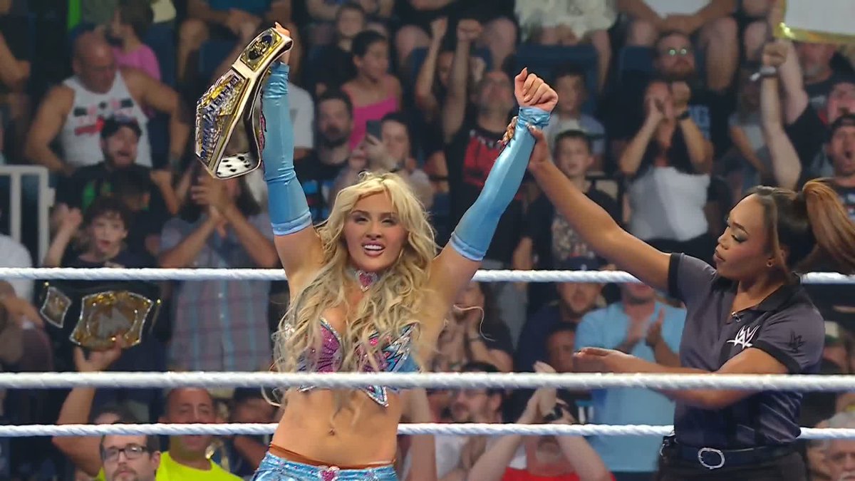 The image depicts a victorious woman holding up a championship belt in a wrestling ring. The post's sentiment suggests this could be someone who has achieved success and recognition within NXT, a WWE developmental territory.