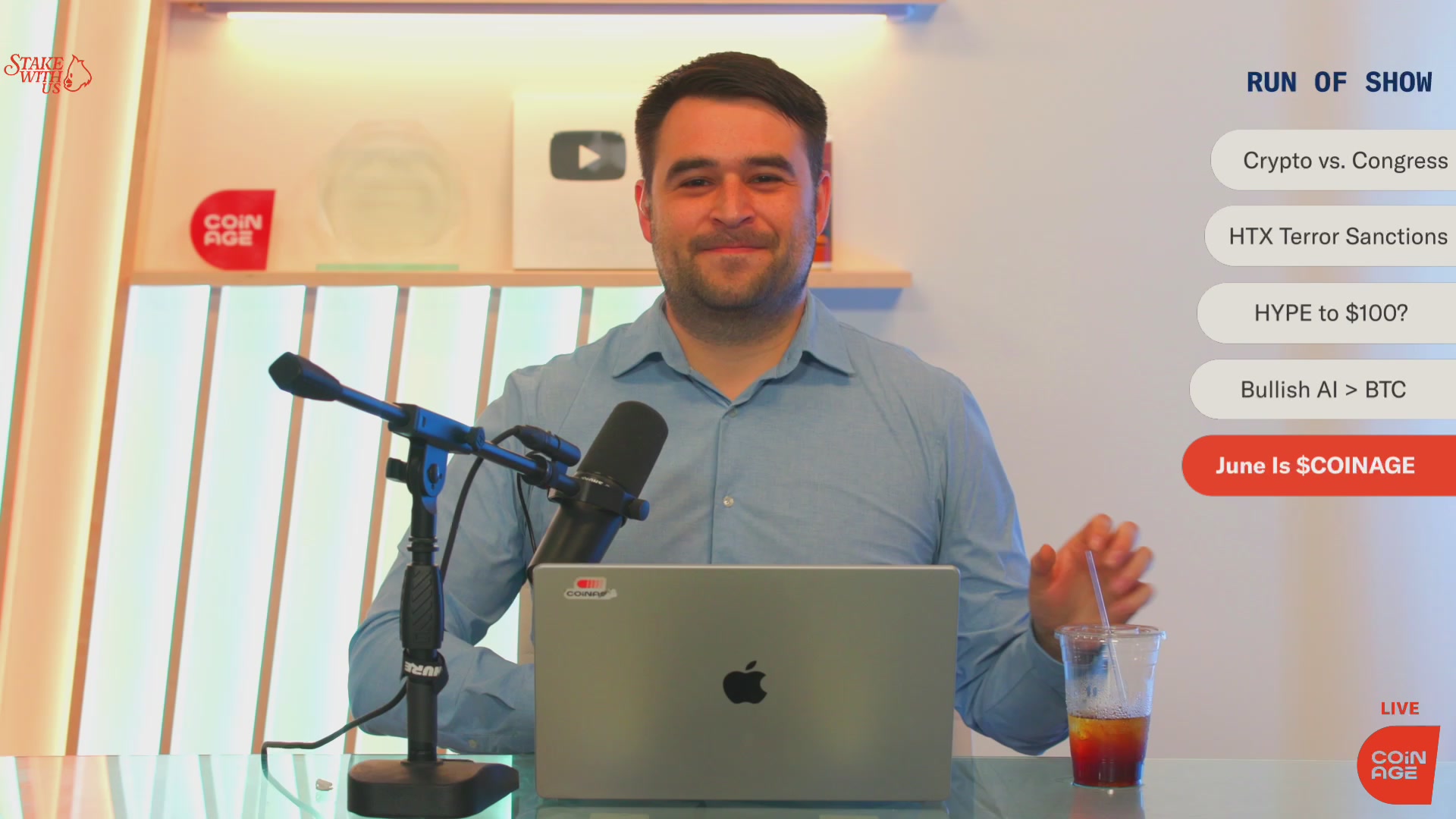 The image features a man sitting at a desk with an Apple laptop, smiling for the camera while holding a glass of beer. The background shows a white wall with a window that allows natural light into the room. There are also two microphones on the desk, one near the man and another further away from him. A caption below the image reads "When we launched $COINAGE last year, it quickly became the largest creator coin on @zora We threw ourselves into the arena with @jessepollak and @brian_armstrong and learned a lot. $COINAGE is still a token on @base and we remain the first tokenized media outlet."
