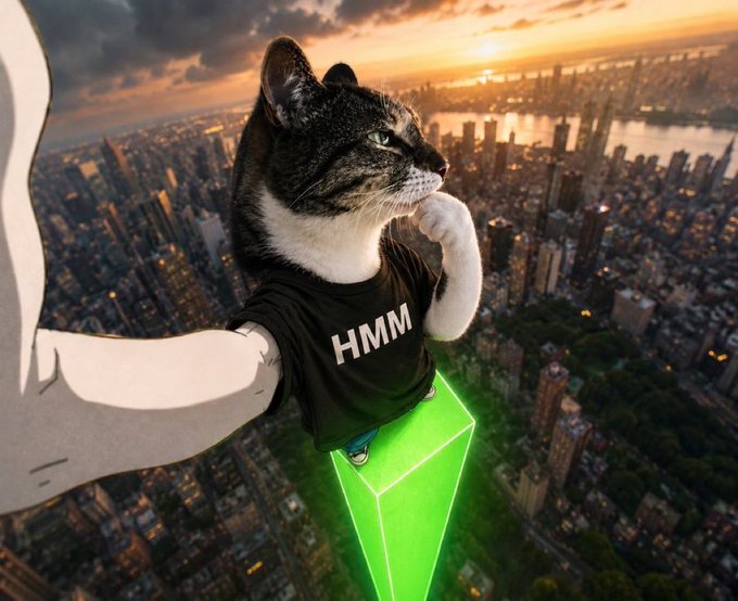 A photoshopped image showing a cat with a human body wearing a 'HMM' t-shirt, posing thoughtfully atop a green neon crystal high above a city skyline at sunset.