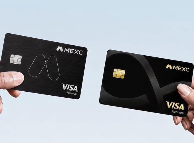 Two hands holding black metal MEXC Visa Platinum cards against a light blue background.