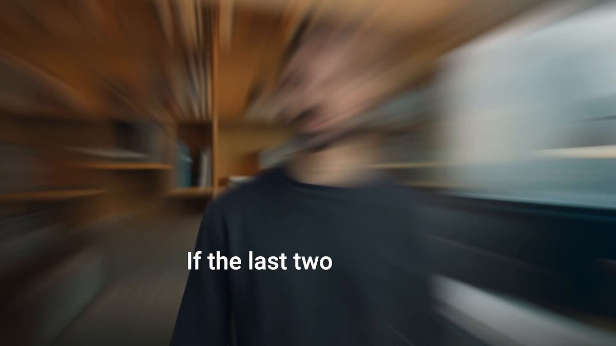 The image features a blurred man wearing a black shirt with white text that reads "If the last two", which appears to be part of an advertisement or promotional material for Endure, a decentralized risk intelligence network. The background shows a blurred view of a room filled with books and furniture, suggesting that this is likely a bookstore or library setting.