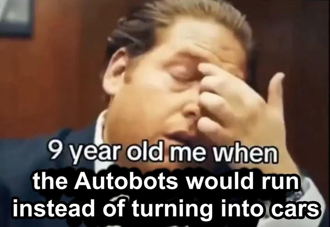 A low-resolution meme image of a man with his hand on his forehead in a facepalm gesture, overlaid with the text '9 year old me when the Autobots would run instead of turning into cars'.
