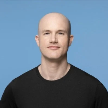 The image shows a bald man in a black sweater against a blue background, identified as Coinbase CEO Brian Armstrong, who is pictured advocating for the passage of the CLARITY Act to establish clear cryptocurrency regulations. His confident expression aligns with his optimistic statement that the industry is "on the one-yard line" in securing definitive crypto rules.