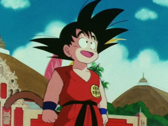 The image features a cartoon character, possibly a dragon or a humanoid figure, standing against a blue sky with clouds. The character appears to be wearing a red outfit and has a large googly eye expression. In the background, there are buildings that add depth to the scene. The caption at the bottom of the image reads "$GOKU Ca- BUvuChjfCJxfUyCRMNWtm2W5ygTc7vV7mK4N22tGpump".
