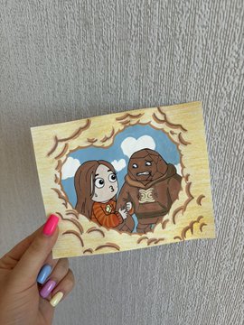 A hand with purple and pink painted nails holds up a small wooden painting depicting a cartoon girl with brown hair using a "puppy eyes" expression on a brown creature, framed by a forest border, illustrating the post's joke about convincing tactics.