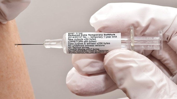 A gloved hand holds a syringe labeled "Reduced Data Temporary Softfork" dated 2014/2015, with text referencing Opus, Bitcoin, and data pushes, injecting into someone's arm as a Bitcoin-related satirical image.