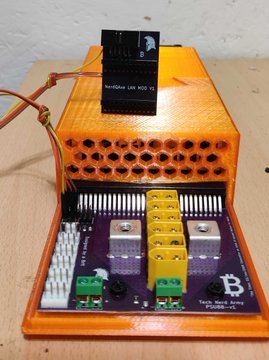 An orange 3D-printed electronics enclosure housing a circuit board with a small black cooling fan labeled 'Nidec U94 80Q', connected by orange wiring.