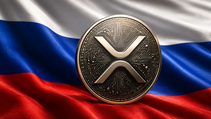 The image features a coin with an x symbol on top of a Russian flag. The coin is made of metal and has a gold-colored design, which makes it stand out against the red, white, and blue colors of the flag. The background of the image is blurred, drawing attention to the coin and its position in front of the flag.
