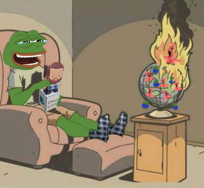 A Pepe the Frog meme shows the character laughing while playing with a 'Chainlink' figurine from a box, as a globe with flaming flamingo figures burns on a nearby table.