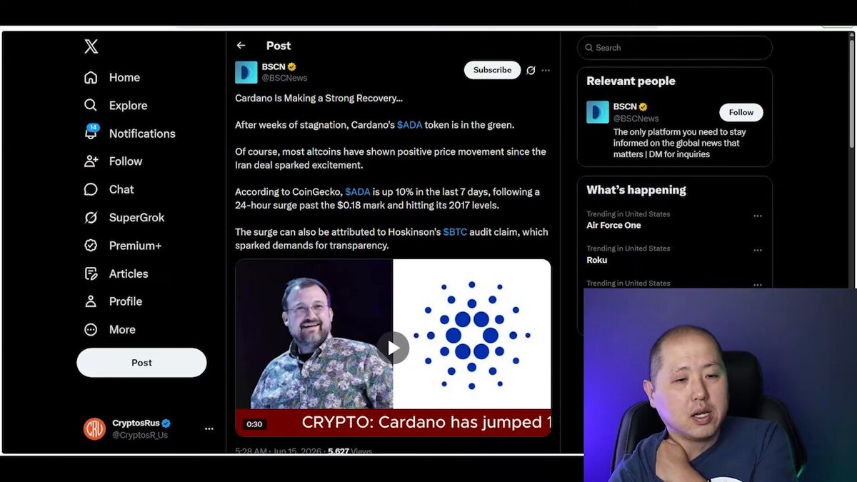 The image shows a man sitting in front of his computer screen with a Twitter chat window open. The chat contains a discussion about cryptocurrency and Charles Hoskinson's defense of Bitcoin, which has been met with criticism from some people. The man seems to be engaged in this conversation, possibly defending the cryptocurrency or trying to educate others about its potential benefits.