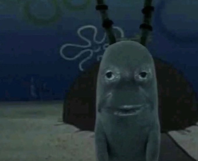 A sad-looking fish character from SpongeBob SquarePants stares forlornly at the camera, used as a reaction meme to express mock sympathy for anyone holding $ANSEM tokens as the price drops. The image's melancholic expression humorously reinforces the post's warning to sell the token before it loses more value.