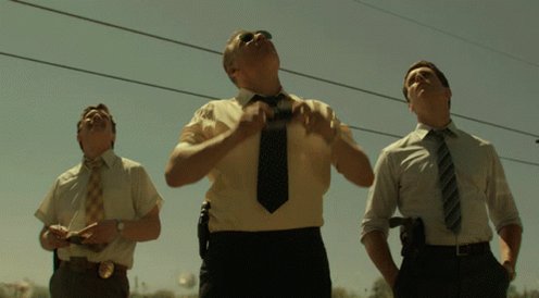 The image shows three men dressed in suits, with one of them adjusting his tie while standing next to two other men who are also wearing ties. The scene appears to take place outdoors or at a street corner, possibly near an intersection. The photo is captioned "gArc most opportunities aren'e hidden they're simply overlooked @TheARCTERMINAL is built around helping users process information more efficiently because in fast-moving markets the difference between seeing something today and seeing it tomorrow can be enormous worth".