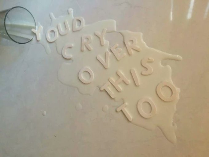 Spilled milk spells out "you'd cry over this too" on a counter. The image playfully illustrates the sentiment of the post, suggesting that after investing so much time and emotion into Twitter Spaces, it now seems silly to care about missing them.