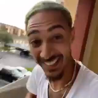 In the image, a man wearing a white t-shirt is standing outside with his mouth open wide, making a funny face or expression that could be interpreted as either laughing or making a silly noise. The background of the photo shows cars parked behind him on a street, which seems to be an urban setting. There's also a car driving past in the image. In relation to this content, the post has the caption: "POV: You bought bitcoin at $120,000". This implies that someone captured and shared a moment of the man making a funny expression with his mouth open wide while standing on a balcony or porch outside. The context suggests that he might have received Bitcoin as payment for some goods or services, perhaps related to this post.