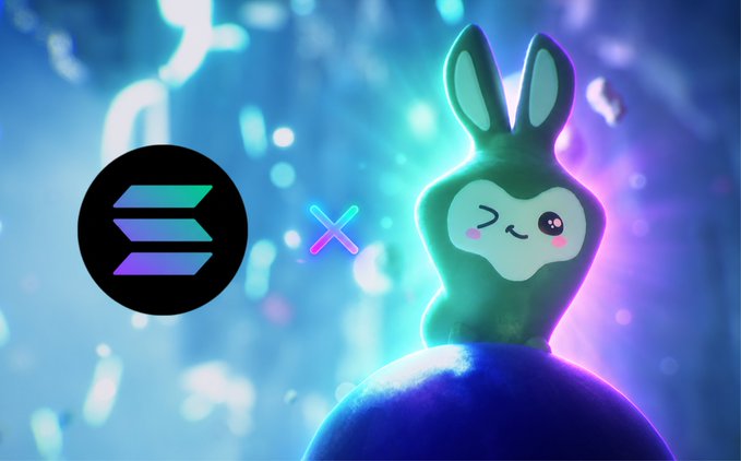 A cartoon bunny character wearing a rabbit-eared hoodie winks beside the Solana logo against a vibrant blue and purple cosmic background, symbolizing a new intellectual property being built on the Solana blockchain. The image visually represents the announcement's excitement about joining the Solana ecosystem and its creative community.
