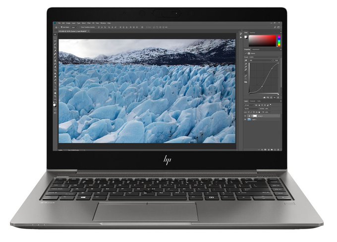 Product photo of an HP laptop displaying Adobe Photoshop with a glacier/iceberg landscape image being edited.