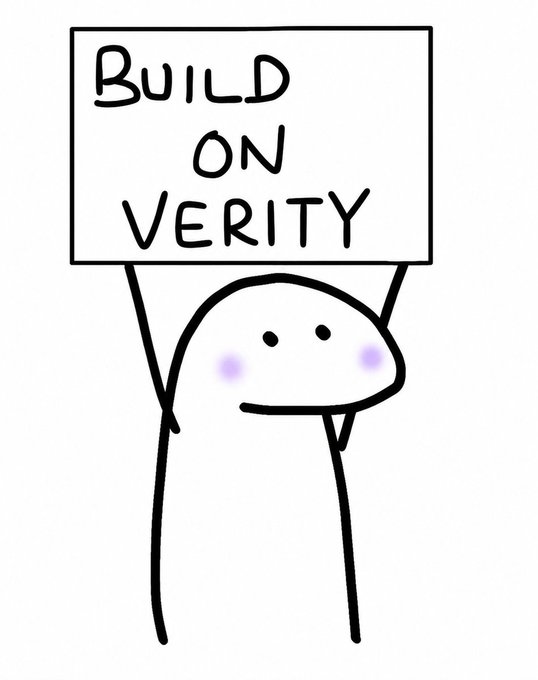 A simple hand-drawn cartoon character with a small smile and blushing purple cheeks holds up a sign reading "BUILD ON VERITY." The image matches the post's "GM, build on Verity" message, visually reinforcing the playful, community-driven call to support the Verity platform.