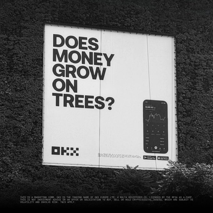 A black-and-white photograph shows the OKX "Does Money Grow on Trees?" billboard featuring the OKX logo and a smartphone displaying a trading chart.

The billboard directly ties into OKX's crypto exchange campaign by promoting their app as a tool for growing wealth through crypto trading, pushing back against the idiom that money doesn't grow on trees.