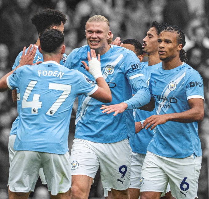 Manchester City players, including Foden (#47) and Haaland (#9), celebrate together in their light blue home kits featuring "OKX" sponsor logos, visually tying the team's on-field success to the post's announcement of a partnership with the official crypto exchange.