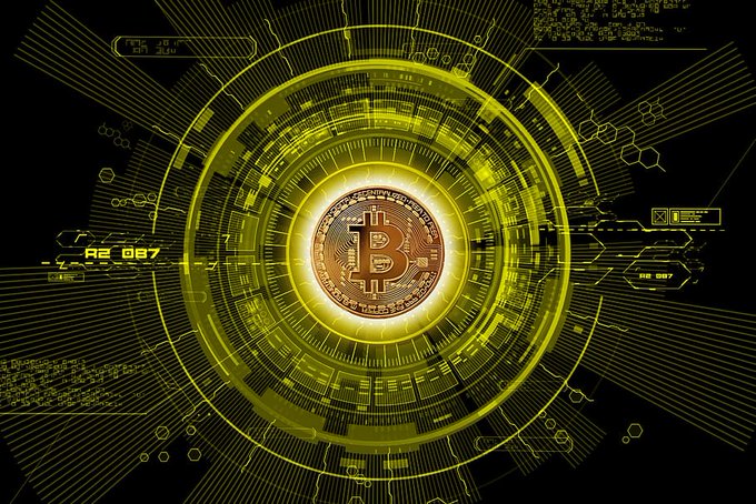 A digital graphic of a Bitcoin coin surrounded by a glowing yellow circular interface with circuit-like patterns and data readouts.
