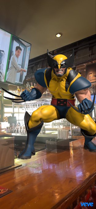 A 3D-rendered Wolverine figure in his classic yellow and blue costume crouches on a bar counter with claws extended, with the "veve" logo visible in the corner.