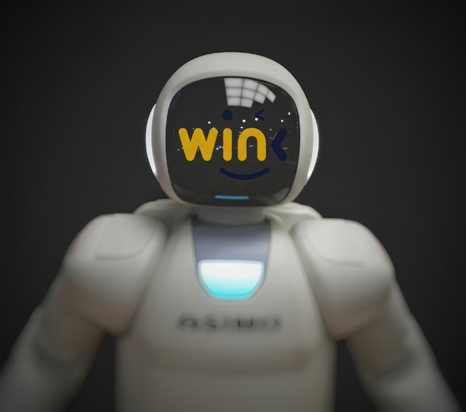 A white humanoid robot with "WIN" displayed in yellow on its digital face is featured, visually reinforcing the post's focus on WINkLink's surging market momentum. The robot's smiling expression and bright display serve as a metaphor for the project's positive short-term performance and growing interest within the TRON ecosystem.