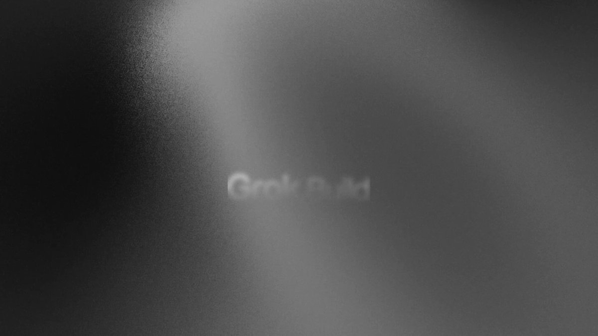 The image shows a large, blurry screen with the words "Grok Build" written across it. The background of the image is black, which contrasts with the white text. The focus of the image is on the words "Grok Build", emphasizing their importance and making them stand out against the dark background.