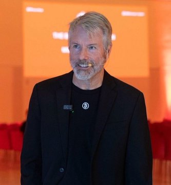 Michael Saylor, founder of Strategy (formerly MicroStrategy, $MSTR), is shown at an event, pictured in connection with the company's recent announcement of expanding its USD reserves by $225 million to $3.22 billion via a common stock ATM offering to fund its perpetual preferred stock dividend obligations.