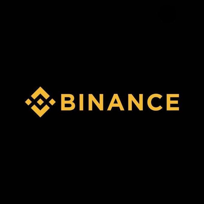 The image displays the Binance logo in gold against a black background, featuring the company's distinctive diamond-shaped symbol alongside the "BINANCE" wordmark. This logo accompanies news that Binance bStocks has overtaken xStocks to become the second-largest tokenized stock issuer, valued at $610.6 million, while Ondo leads the market with approximately $927 million.