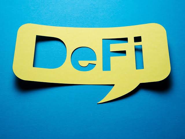A yellow paper cutout of the word 'DeFi' in a speech bubble shape against a bright blue background.