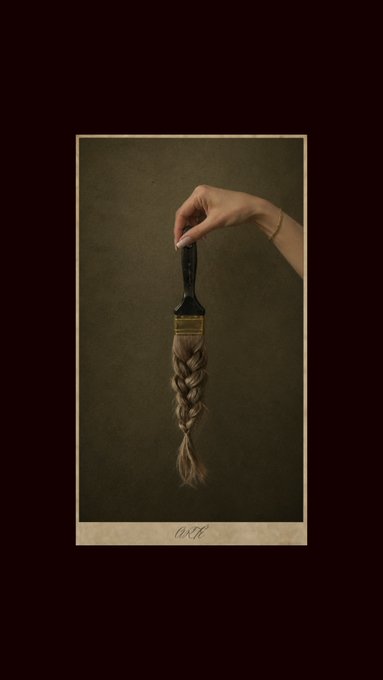A surreal artistic image showing a hand holding a paintbrush where the bristles have been replaced by a long braided lock of blonde hair, framed with the text 'EXIT' at the bottom.